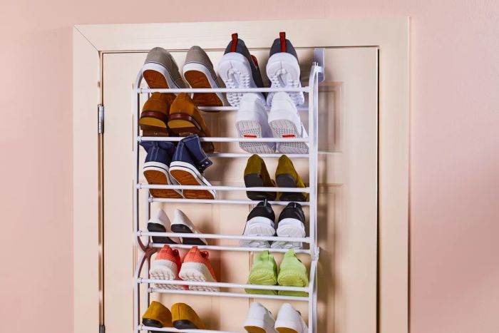 The Whitmor Over-the-Door Shoe Rack is mounted on a door with shoes being organized on it