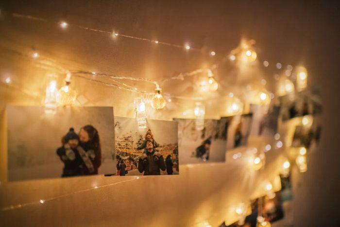 Family photos at Christmas on display using a Christmas light