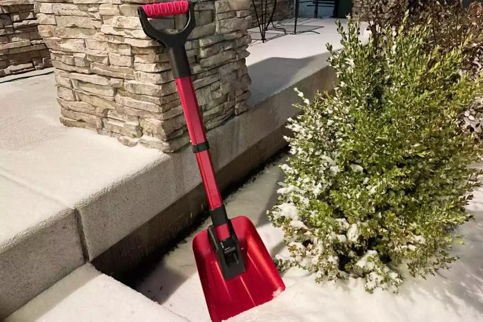 BirdRock 34-inch Folding Emergency Snow Shovel shown against a stone pillar