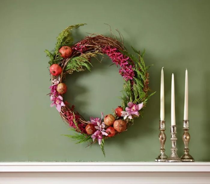 Holiday decorating ideas, Mantel wreath adorned with flowers and pomegranates