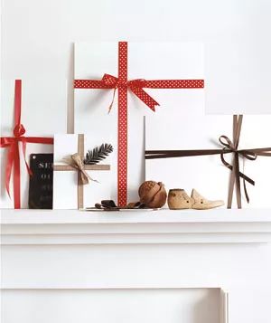 A festive Christmas decoration idea: blank art canvases wrapped in colorful ribbon.