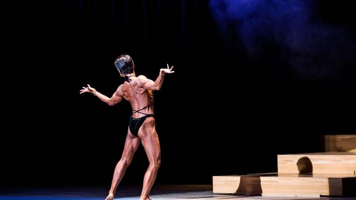 A rear view of a female bodybuilder.