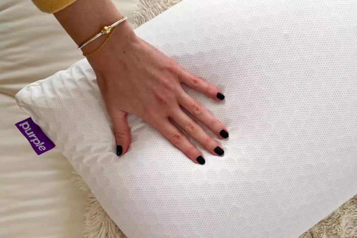 Someone gently patting a Purple Pillow