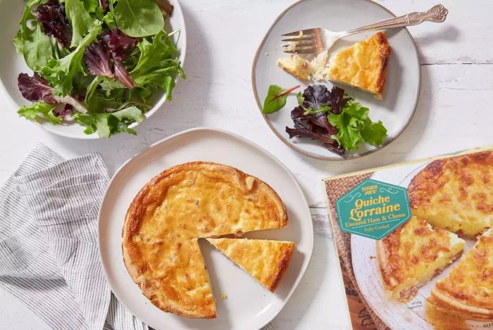 Sliced and served alongside a salad, Trader Joe’s Quiche Lorraine makes for a tasty dish.