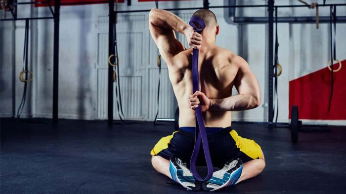 A person stretching his shoulders by reaching his arms behind his back.