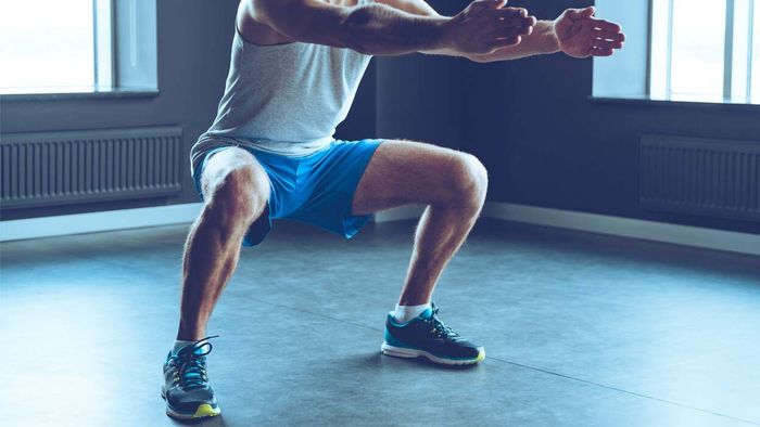 man performing a squat
