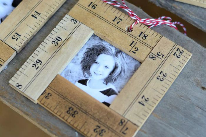 A ruler photo ornament set against a wooden backdrop.