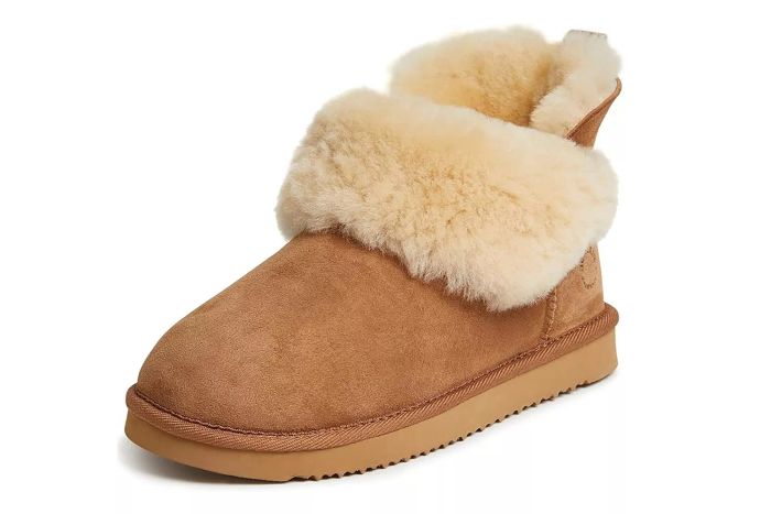 The Dearfoams Women's Fireside Genuine Shearling Water-Resistant Boots offer both protection from the elements and a cozy fit for those colder days.