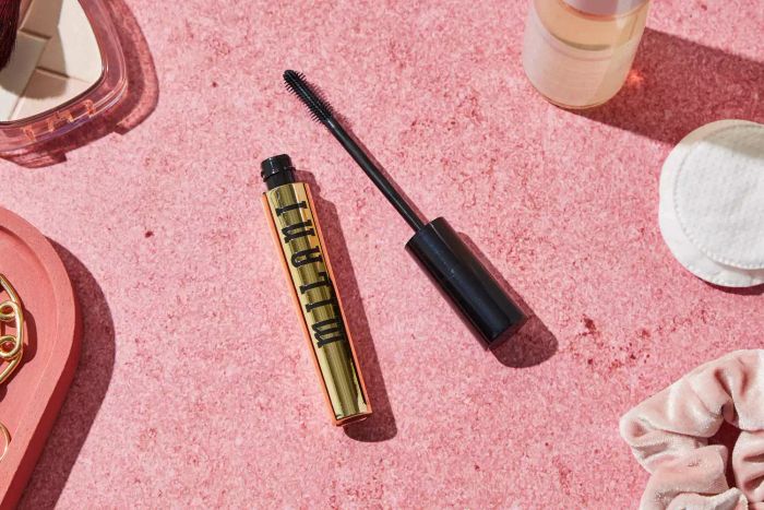 An open tube of Milani Highly Rated Lash Extensions Tubing Mascara against a pink background