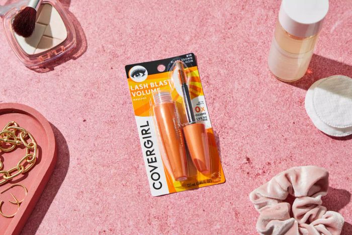 The CoverGirl LashBlast Volume Waterproof Mascara displayed in its packaging against a soft pink backdrop
