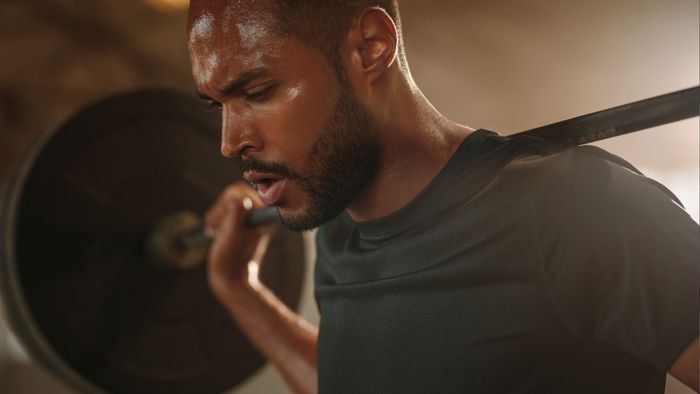 individual performing a squat
