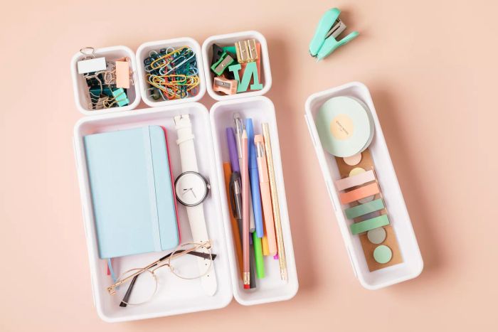 Desktop organization. Cleaning up messy stationery in plastic organizers for office and home desk