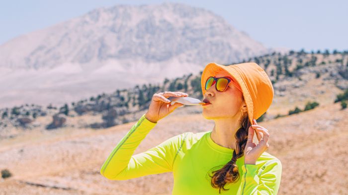 athlete consuming an energy gel