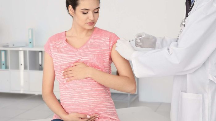 pregnant woman getting a vaccine