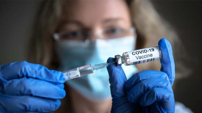 healthcare professional administering vaccine with syringe