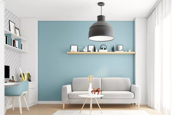 Living room and home office with a sleek black pendant light overhead