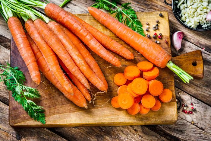 carrots placed on a wooden cutting board