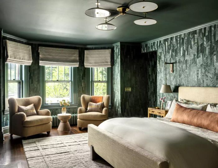 a primary bedroom featuring dark green walls and ceiling