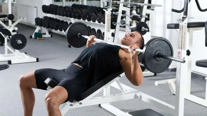 A man getting ready for an incline bench press. I’m sure he’s capable of lifting even more.