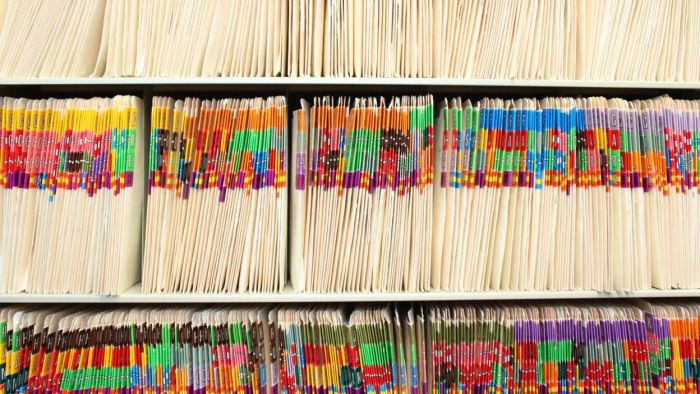 Rows of color-coded folders neatly arranged on a shelf