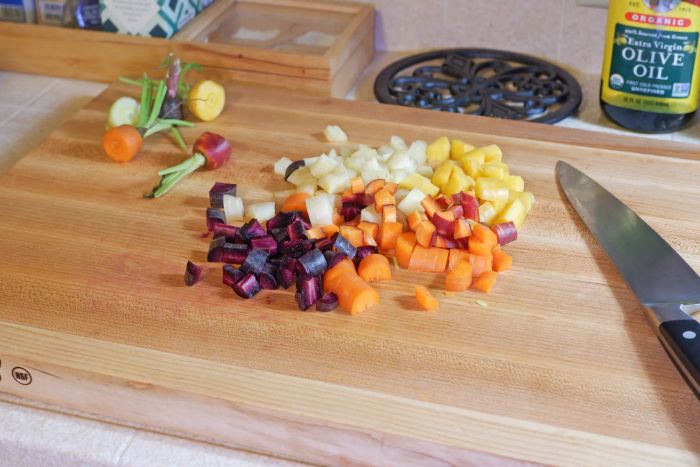 Chopped vegetables displayed on the John Boos Chop-N-Slice Maple Wood Reversible Cutting Board