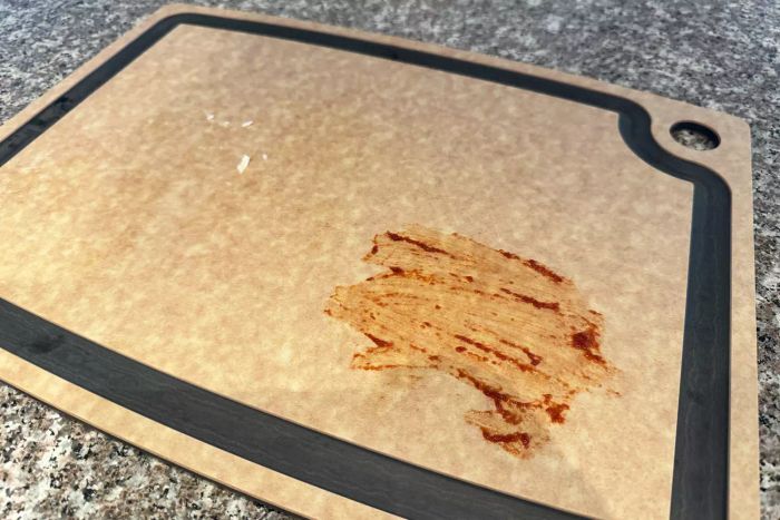 The Epicurean 17.5 x 13 Inch Gourmet Series Groove Cutting Board with sauce on it