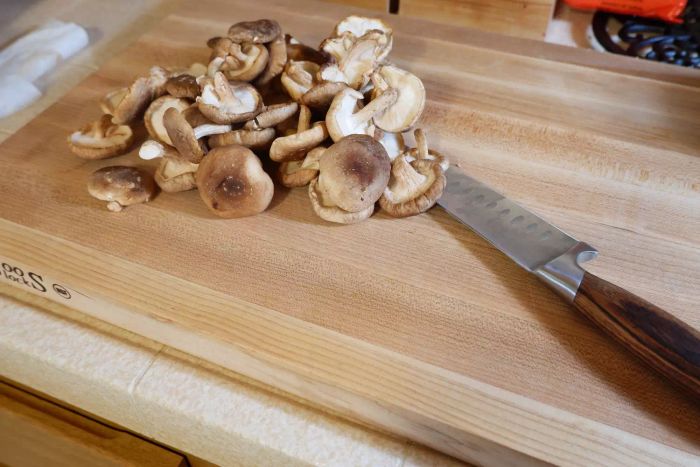 Mushrooms are chopped on the John Boos Chop-N-Slice Maple Wood Reversible Cutting Board