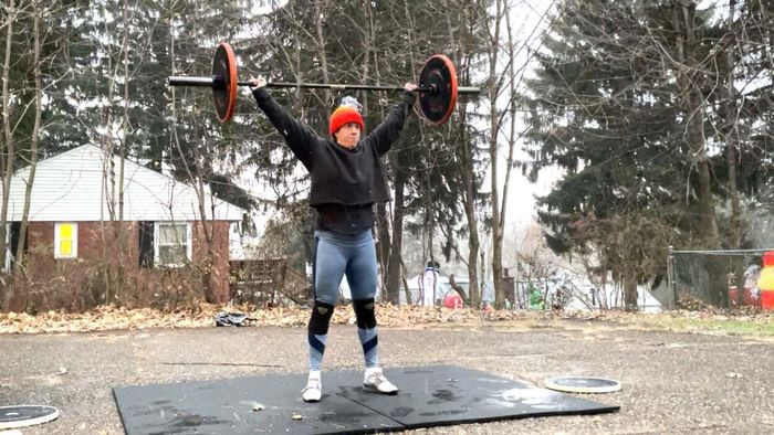 The author lifting a barbell outside while donning a winter hat