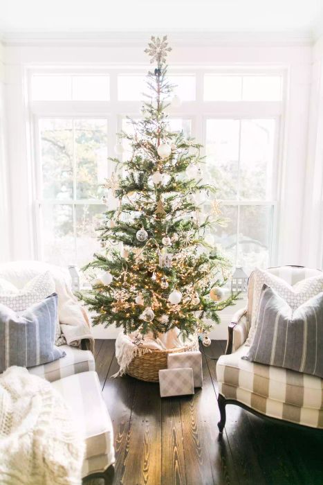 A Christmas tree adorned with silver and white decorations