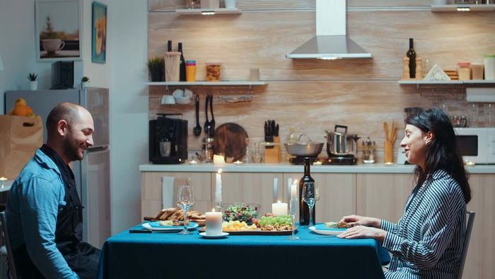 Just two people sharing a meal in the kitchen. ONLY two.