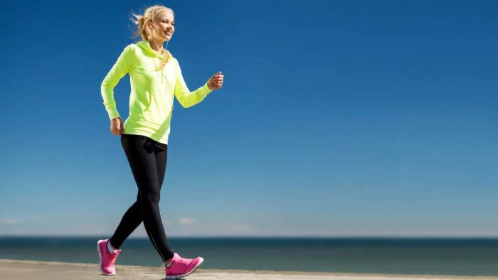 A woman walking in vibrant workout attire