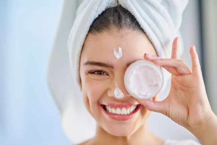 Smiling Woman Holding a Skincare Product