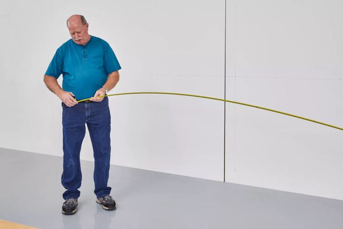 A person taking measurements using an Irwin Strait-Line Tape Measure