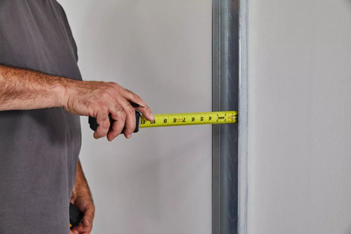 A person extending the Crescent Lufkin Shockforce Dual-Sided Tape Measure