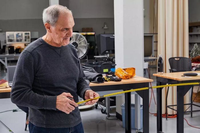 A person extending the Crescent Lufkin Shockforce Dual-Sided Tape Measure