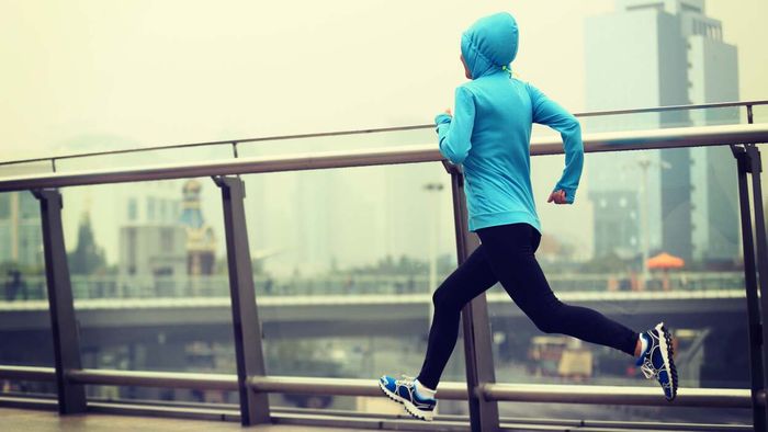Runner in a smoke-filled city