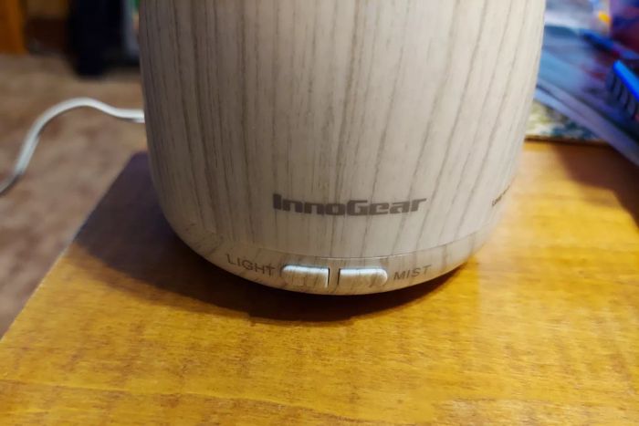A close-up view of the InnoGear Essential Oil Diffuser placed on a wooden table