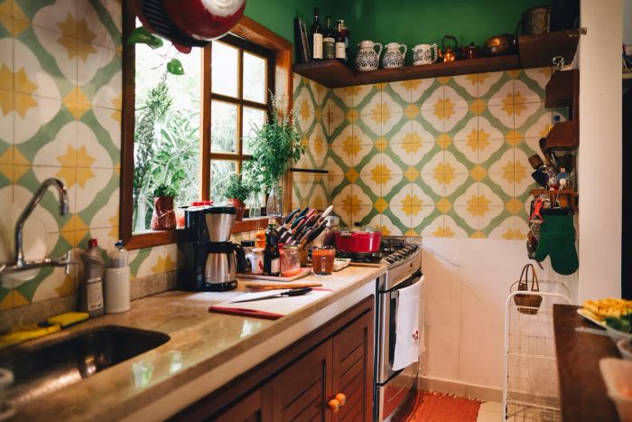A pot of food simmering on a stove in a tiled kitchen, devoid of people