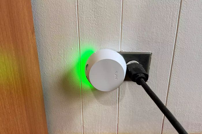 The Pura Home Fragrance Diffuser plugged into an outlet