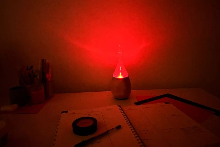 The Organic Aromas Raindrop Nebulizing Diffuser in operation with its red light illuminated