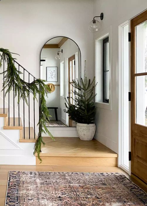 arched mirror in entryway by stairs