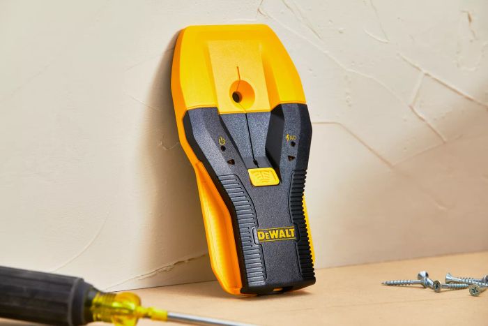 Dewalt 1-1/2 in. Stud Finder placed on a wooden table alongside screws