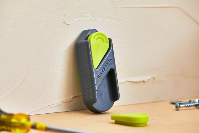 Calculated Industries 7310 StudMark Magnetic Stud Finder shown in use against a wall
