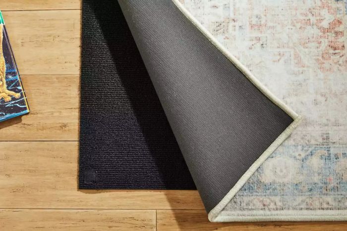 The Ruggable Kamran Rug lifted on a wooden floor