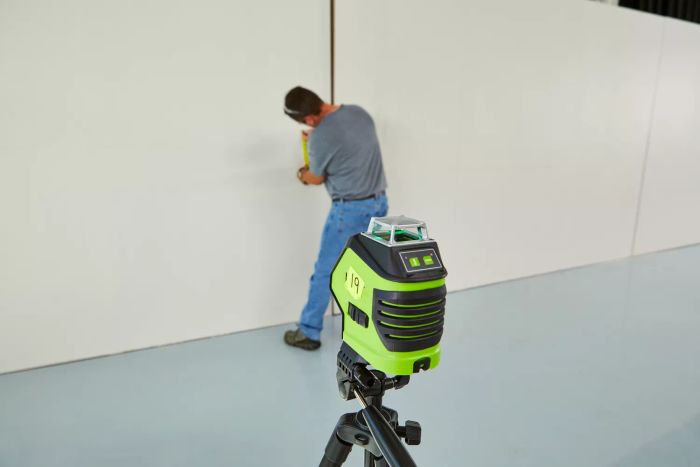 The Huepar 621CG 3D Cross-Line Self-Leveling Green Laser Level, designed for precise wall measurement by an individual