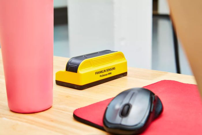 Franklin Sensors ProSensor M90 Professional Stud Finder placed on a wooden table