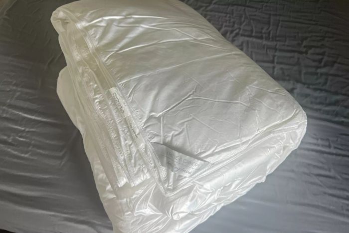 The Crane & Canopy Ultimate Luxe Down Alternative Comforter neatly folded on a bed