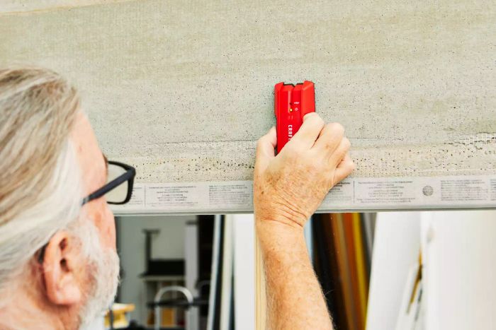 A person using the Craftsman 3/4-Inch Depth Stud Finder against a wall