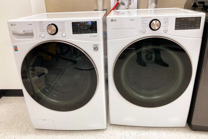 The LG Electronics WM4000HWA Ultra Large Capacity Front Load Washer and dryer set showcased in a laundry room setting.