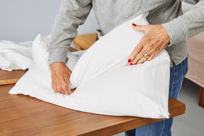 A person bends the Beautyrest Latex Foam Bed Pillow in half